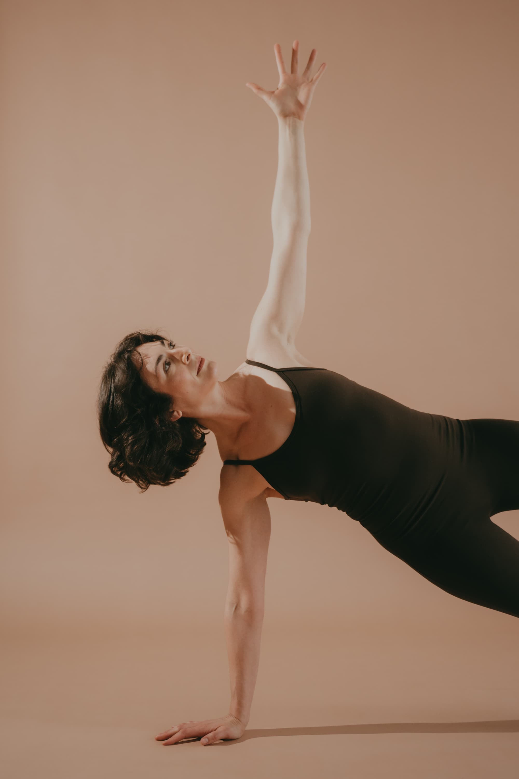 Emilie Young in side plank with reaching arm